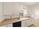 Modern kitchen with white cabinets, stainless steel dishwasher and ample countertop space at 5500 Se 2Nd Pl, Ocala, FL 34480