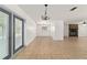 Large main room with backyard access, updated lighting, and tile flooring at 5500 Se 2Nd Pl, Ocala, FL 34480