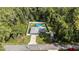 Aerial view of home featuring an above ground pool in a fenced backyard, driveway, and wooded surroundings at 6 Sequoia Loop, Ocklawaha, FL 32179