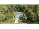 Aerial view of fenced backyard with above ground pool and gazebo in a wooded neighborhood at 6 Sequoia Loop, Ocklawaha, FL 32179
