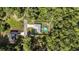 An aerial view of a fenced backyard with an above ground pool in a wooded neighborhood at 6 Sequoia Loop, Ocklawaha, FL 32179