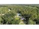 A wooded neighborhood featuring an aerial view of a home, a pool, and a driveway at 6 Sequoia Loop, Ocklawaha, FL 32179