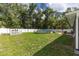 Wide view of the backyard with an above-ground pool, fencing, and green grass at 6 Sequoia Loop, Ocklawaha, FL 32179