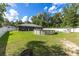 The backyard features a large above ground pool and is surrounded by a white vinyl fence at 6 Sequoia Loop, Ocklawaha, FL 32179