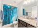 Bathroom featuring a granite countertop, dark wood cabinets and a bathtub/shower combination at 6 Sequoia Loop, Ocklawaha, FL 32179
