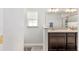 Bright bathroom featuring a double vanity with stone counter and light fixtures at 6 Sequoia Loop, Ocklawaha, FL 32179
