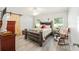 Bright bedroom with stylish barn door, ceiling fan, and light gray wood-look flooring at 6 Sequoia Loop, Ocklawaha, FL 32179