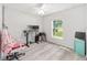 Bright bedroom with ceiling fan, wood floors, and a window view to the outdoors at 6 Sequoia Loop, Ocklawaha, FL 32179