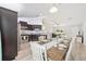 View of the kitchen and dining area with a long table set for a meal and an open concept at 6 Sequoia Loop, Ocklawaha, FL 32179