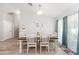 Bright dining room featuring a wooden table and chairs, with natural light from large windows at 6 Sequoia Loop, Ocklawaha, FL 32179