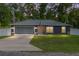 Charming single-story home with a well-maintained lawn and a two-car garage at 6 Sequoia Loop, Ocklawaha, FL 32179