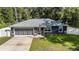 A charming one story home with a two car garage, surrounded by a fence at 6 Sequoia Loop, Ocklawaha, FL 32179