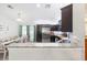 Open concept kitchen with stainless steel appliances, granite countertops, and dark wood cabinetry at 6 Sequoia Loop, Ocklawaha, FL 32179
