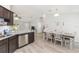 Kitchen with dark wood cabinets, stainless steel appliances, and an adjacent dining area at 6 Sequoia Loop, Ocklawaha, FL 32179