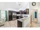 A kitchen with granite countertops, stainless appliances and dark wood cabinets at 6 Sequoia Loop, Ocklawaha, FL 32179