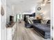 Open-concept living room with hardwood floors, modern furnishings, and lots of natural light at 6 Sequoia Loop, Ocklawaha, FL 32179