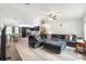 Open-concept living room with gray sectional sofa, flowing into the dining area and kitchen at 6 Sequoia Loop, Ocklawaha, FL 32179