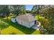 Aerial view of the home showcasing its well-maintained lawn, two-car garage, and lush landscaping at 6113 Sw 101St Pl, Ocala, FL 34476