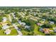 A sunny aerial view of a neighborhood with well-maintained homes, green lawns and mature trees at 6113 Sw 101St Pl, Ocala, FL 34476