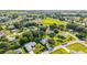 An aerial view showcases a neighborhood with well-maintained homes, green lawns, and mature trees on a sunny day at 6113 Sw 101St Pl, Ocala, FL 34476