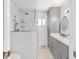 Modern bathroom boasts updated vanity, marble countertops, and glass shower at 6113 Sw 101St Pl, Ocala, FL 34476