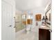 Bathroom features a shower with glass doors, marble floors, and a vanity with granite countertops at 6113 Sw 101St Pl, Ocala, FL 34476
