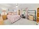 Bright bedroom features a ceiling fan, large window, and furnishings with a classic style and a calming color scheme at 6113 Sw 101St Pl, Ocala, FL 34476