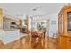 Dining room with hardwood floors, overhead lighting and kitchen views at 6113 Sw 101St Pl, Ocala, FL 34476