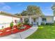 Beautiful one-story home with a manicured front yard, enhanced by colorful landscaping at 6113 Sw 101St Pl, Ocala, FL 34476