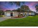 Beautiful one-story home featuring a well-manicured lawn and charming curb appeal during sunset at 6113 Sw 101St Pl, Ocala, FL 34476