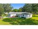 Aerial view of home showcasing meticulous landscaping, verdant lawn, and pristine facade at 6113 Sw 101St Pl, Ocala, FL 34476