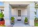Inviting front porch with decorative columns and potted plants creating a warm welcome at 6113 Sw 101St Pl, Ocala, FL 34476