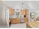 Bright kitchen features stainless appliances, tile backsplash, and sunny window view at 6113 Sw 101St Pl, Ocala, FL 34476
