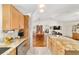 Gourmet kitchen with granite countertops and stainless steel appliances adjacent to dining and living areas at 6113 Sw 101St Pl, Ocala, FL 34476