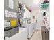 Laundry room features modern appliances, white cabinets, and open shelves for storage, plus energy-efficient features at 6113 Sw 101St Pl, Ocala, FL 34476