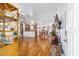 Open-concept living area showcasing hardwood floors and seamless flow to kitchen and dining at 6113 Sw 101St Pl, Ocala, FL 34476