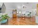 Cozy living room with hardwood floors, bright window views, and comfortable seating at 6113 Sw 101St Pl, Ocala, FL 34476