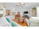 Spacious living room featuring hardwood floors, white walls, and comfortable seating arrangements at 6113 Sw 101St Pl, Ocala, FL 34476