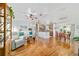 Open-concept living space with hardwood floors, neutral walls, and view into the kitchen and dining area at 6113 Sw 101St Pl, Ocala, FL 34476