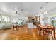 Open-concept living room and dining area features hardwood floors and flows into a modern kitchen at 6113 Sw 101St Pl, Ocala, FL 34476