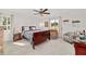 Cozy main bedroom showcases a ceiling fan, windows, and plush carpet at 6113 Sw 101St Pl, Ocala, FL 34476