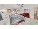 Comfortable main bedroom includes carpet, window, and dark wood furniture at 6113 Sw 101St Pl, Ocala, FL 34476