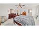 Large main bedroom with carpet flooring and elegant, dark wood furniture at 6113 Sw 101St Pl, Ocala, FL 34476