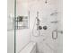 Walk-in shower features marble tiling, glass door and convenient shower seat at 6113 Sw 101St Pl, Ocala, FL 34476