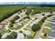 This aerial shot shows a community with homes nestled among a lush, green landscape with mature trees at 6330 Sw 117Th Loop, Ocala, FL 34476