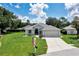 Charming single-story home with a well-manicured lawn and a two-car garage on a sunny day at 6330 Sw 117Th Loop, Ocala, FL 34476