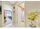 Hallway with an open view to a bedroom and bathroom, features tiled flooring and a decorative vase at 6330 Sw 117Th Loop, Ocala, FL 34476