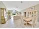 Open-concept living room with large windows providing natural light, tile floors, and neutral furnishings at 6330 Sw 117Th Loop, Ocala, FL 34476