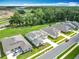 An elevated view of homes near a highway construction site, set against a backdrop of lush green areas and sky at 7067 Sw 60Th Ln, Ocala, FL 34474