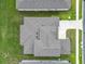 Aerial view of a house with a gray shingled roof and green lawn with neighboring homes nearby at 7067 Sw 60Th Ln, Ocala, FL 34474